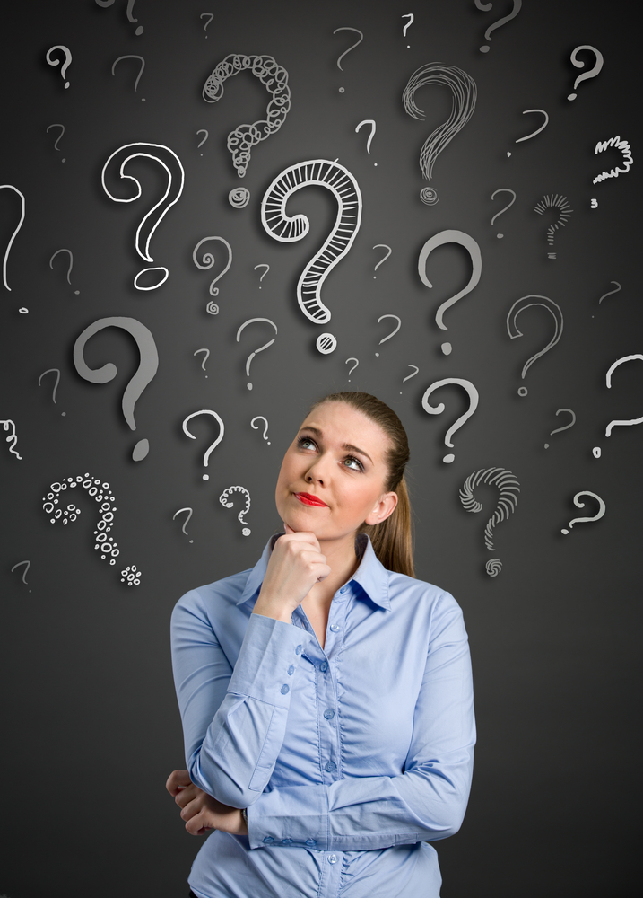 Woman looking up with question marks above her head